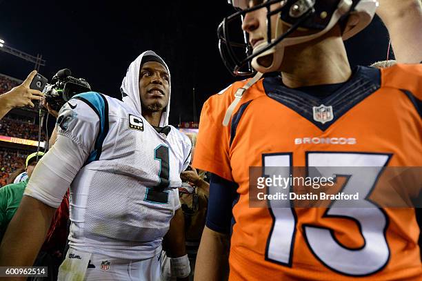 Quarterback Cam Newton of the Carolina Panthers reacts after shaking hands on the field with quarterback Trevor Siemian of the Denver Broncos after a...