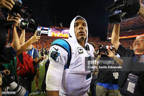 Quarterback Cam Newton of the Carolina Panthers walks off the field after losing to the Broncos 21-20 at Sports Authority Field at Mile High on...