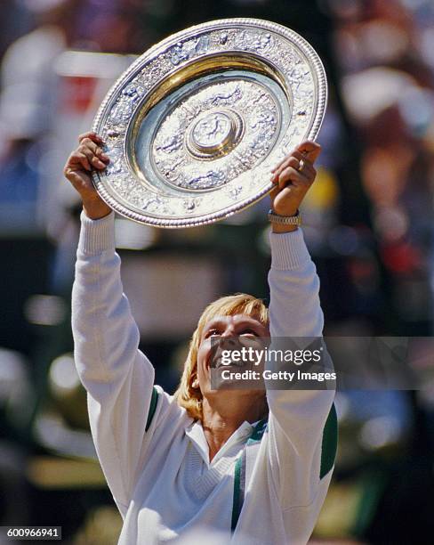 Martina Navratilova of the United States holds the Rosewater Plate aloft after winning the Women's Singles Final match against Steffi Graf at the...