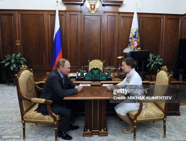 Russian President Vladimir Putin meets with the newly-appointed Russia's children's rights ombudswoman Anna Kuznetsova at the Kremlin in Moscow on...