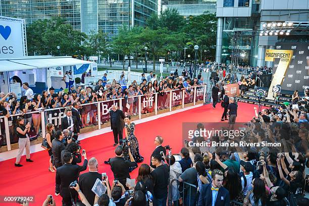 Actress Ziyi Zhang poses for the photographers as fans snap photos with their phones at 'The Magnificent Seven' premiere during the 2016 Toronto...