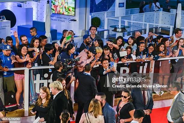 Actor Byung-hun Lee takes a selfie with fans at 'The Magnificent Seven' premiere during the 2016 Toronto International Film Festival at Roy Thomson...