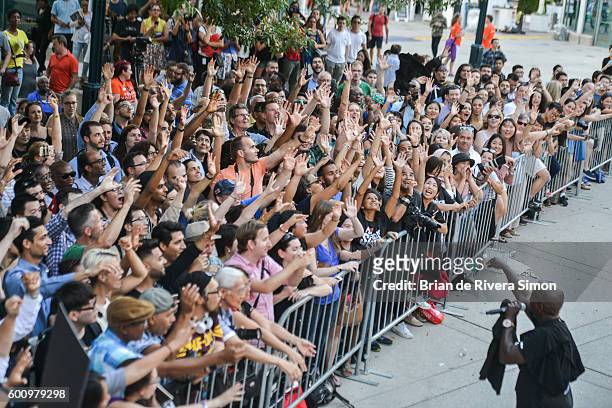 Fans reaching out for the free giveaway t-shirts at 'The Magnificent Seven' premiere during the 2016 Toronto International Film Festival at Roy...