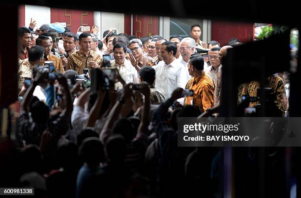 Indonesian President Joko Widodo and Philippine President Rodrigo Duterte visit Tanah Abang market in Jakarta on September 9, 2016. American...