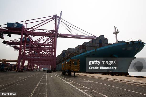 An A.P. Moeller-Maersk A/S branded container ship sits moored next to gantry cranes at the Hanjin Newport Co. Terminal, a unit of Hanjin Group, at...