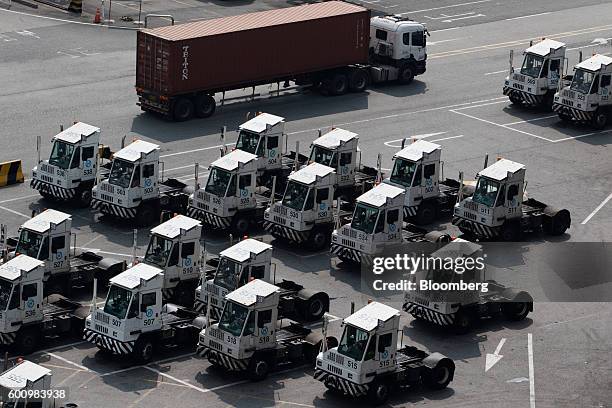 Truck drives past parked yard trailers at the Hanjin Newport Co. Terminal, a unit of Hanjin Group, at Busan New Port in Busan, South Korea, on...