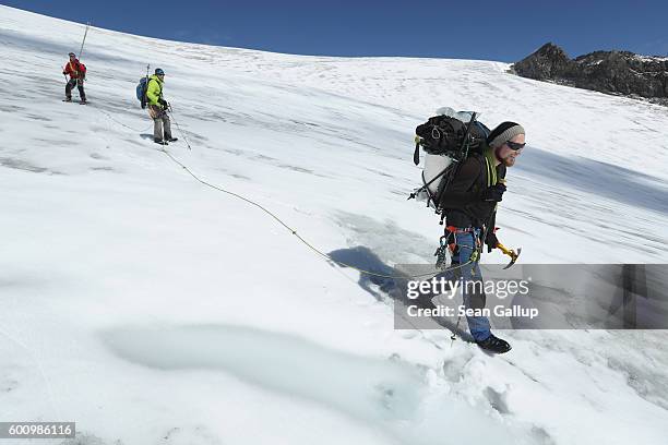 Martin Stocker-Waldhuber, a glaciologist with the Austrian Institute for Interdisciplinary Mountain Research who is carrying a kettle for a device...