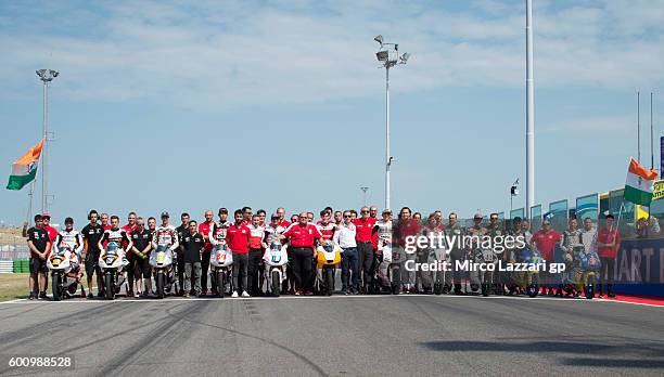 Mufaddal Choonia of India and CEO Mahindra Racing celebrates with team members and Moto3 riders the Mahindra Racing 100th GP during MotoGP of San...