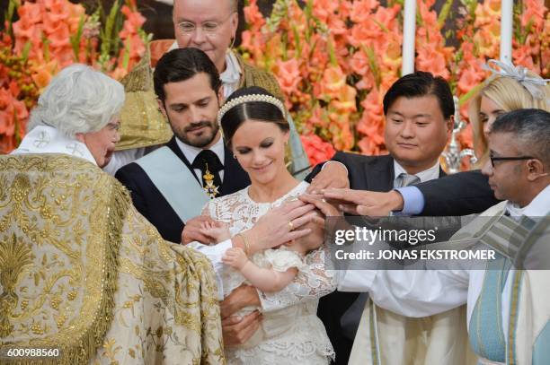 Princess Sofia holds her son Prince Alexander, while Arch Bishop Antje Jackelen , Prince Carl Philip , godparents Jan-Ake Hansson, and Lina Frejd and...