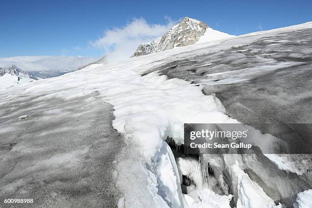 Icicles hang in a crevasse on the upper section of the Outer Mullwitzkees glacier on September 8, 2016 near Hinterbichl, Austria. A team from the...