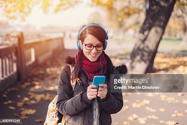 student girl texting in the park - krakow park stock pictures, royalty-free photos & images