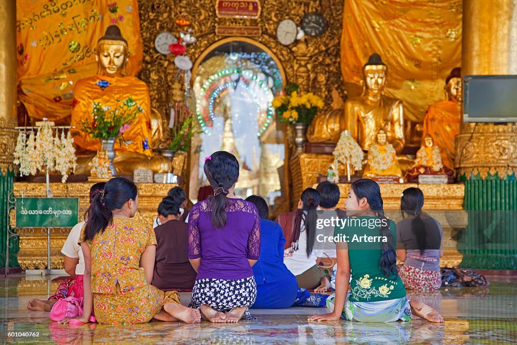 Burmese women praying barefooted in the Shwedagon Zedi Daw Pagoda at Yangon / Rangoon