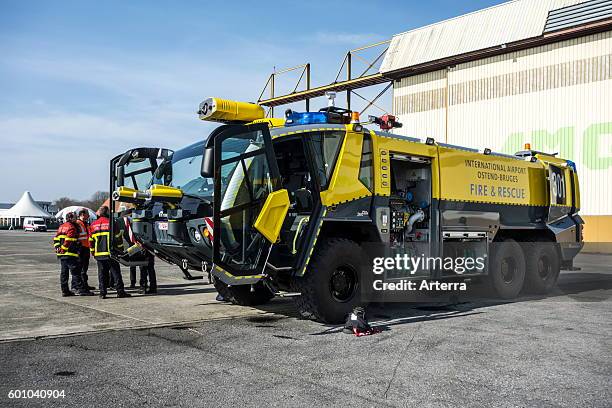 Firefighters and airport crash tender Rosenbauer Panther CA-5 6x6 at the Ostend aerodrome, Belgium.