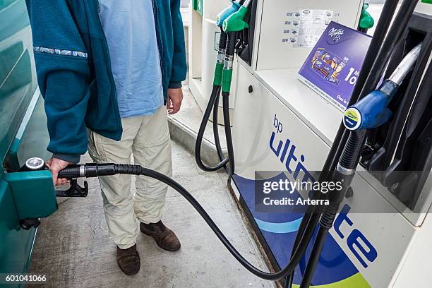 Man pumping fuel into his vehicle at BP service station.