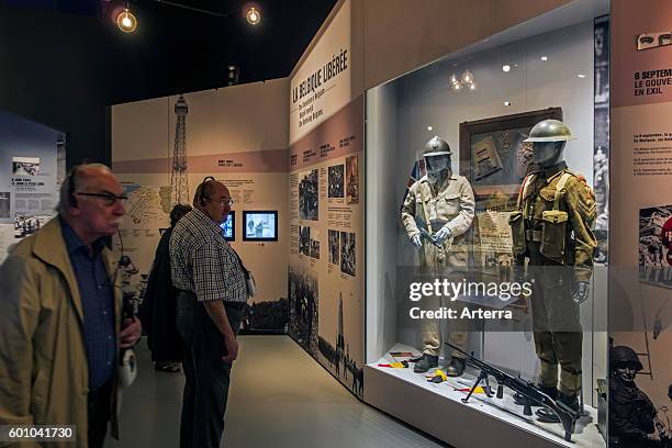 Tourists with audio guides visiting the Bastogne War Museum devoted to the Second World War Two Battle of the Bulge in the Belgian Ardennes, Belgium.