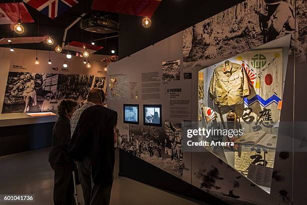 Tourists with audio guides visiting the Bastogne War Museum devoted to the Second World War Two Battle of the Bulge in the Belgian Ardennes, Belgium.