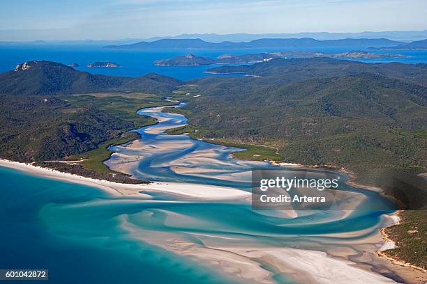 Areal view of white sandy beaches and turquoise blue water of Whitehaven Beach on Whitsunday Island in the Coral Sea, Queensland, Australia.