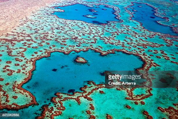 Aerial view of heart-shaped Heart Reef, part of the Great Barrier Reef of the Whitsundays in the Coral sea, Queensland, Australia.