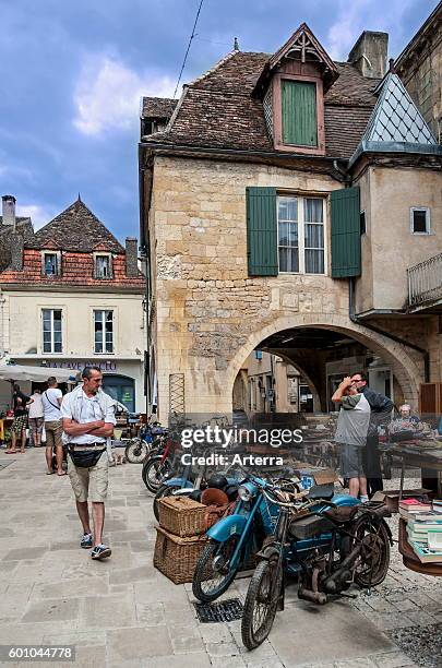 Brocante and old motorbikes for sale at market square of the English bastide town Beaumont-du-Perigord, Perigord, Dordogne, Aquitaine, France.