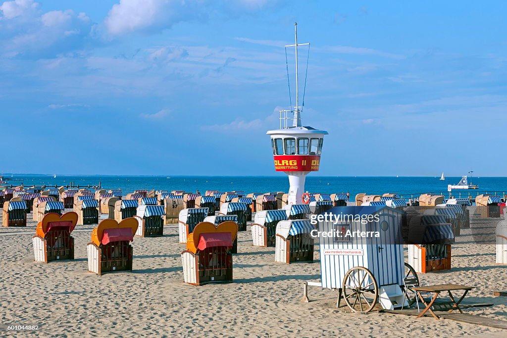 Roofed wicker beach chairs on the beach at Travemuende