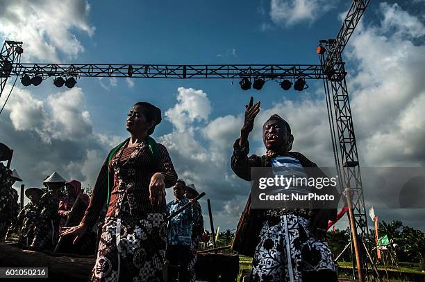 Two citizens do traditional dance during Gejog Lesung festival in Yogyakarta, Indonesia, on September 9, 2016. Gejog lesung is traditional arts from...