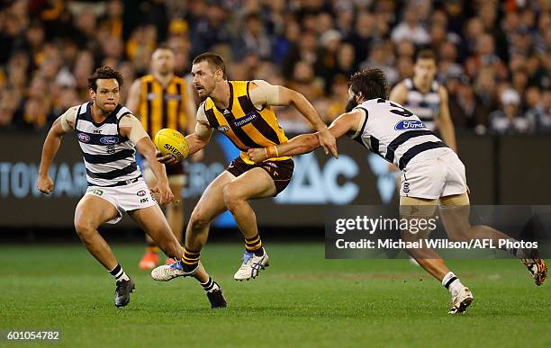 Brendan Whitecross of the Hawks is tackled by Jimmy Bartel of the Cats during the 2016 AFL Second Qualifying Final match between the Geelong Cats and...