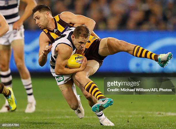 Joel Selwood of the Cats is tackled by Jack Gunston of the Hawks during the 2016 AFL Second Qualifying Final match between the Geelong Cats and the...