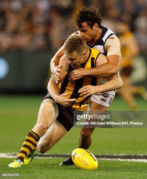 Sam Mitchell of the Hawks is tackled by Steven Motlop of the Cats during the 2016 AFL Second Qualifying Final match between the Geelong Cats and the...