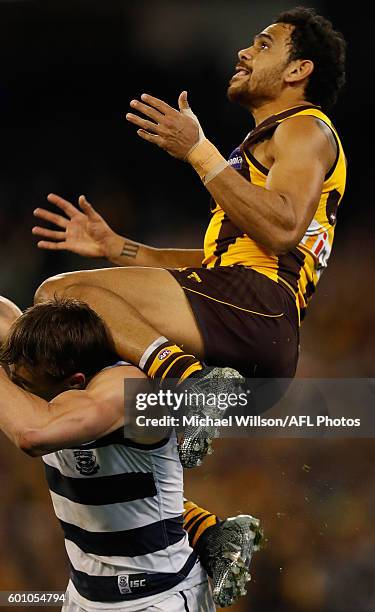 Cyril Rioli of the Hawks takes a spectacular mark over Corey Enright of the Cats during the 2016 AFL Second Qualifying Final match between the...