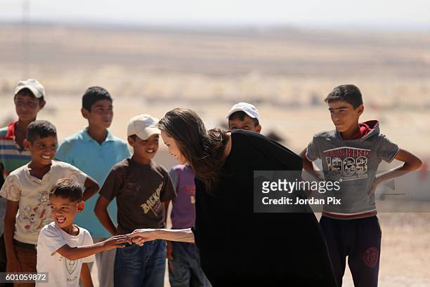 Actress and UNHCR special envoy and Goodwill Ambassador Angelina Jolie greets children during a press conference at Al- Azraq camp for Syrian...