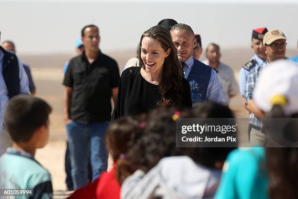 Actress and UNHCR special envoy and Goodwill Ambassador Angelina Jolie greets children during a press conference at Al- Azraq camp for Syrian...