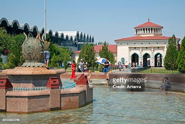 Children playing in fountain in front of the Chorsu Bazaar in the center of the old town of Tashkent, capital city of Uzbekistan .