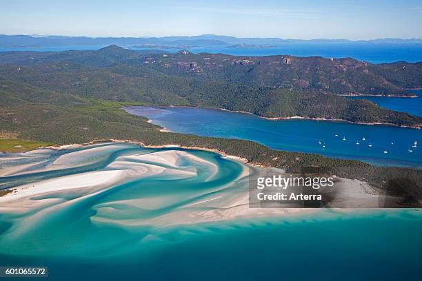 Areal view of white sandy beaches and turquoise blue water of Whitehaven Beach on Whitsunday Island in the Coral Sea, Queensland, Australia.