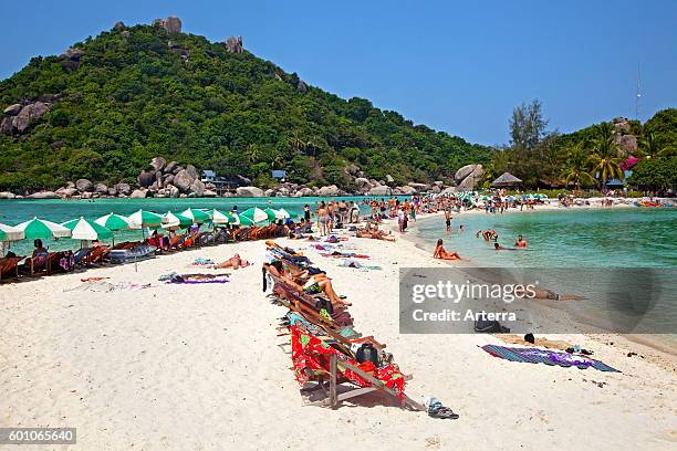 Western tourists sunbathing on beach of Ko Nang Yuan / Nangyuan, small island near Ko Tao along the Central Gulf Coast in Southern Thailand.