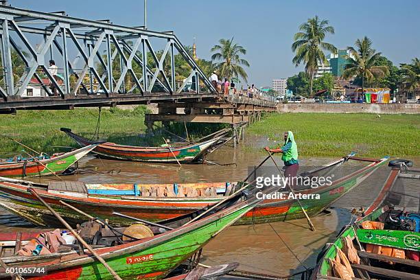 Colourful traditional longtail boats in the Yangon river, Yangon / Rangoon, former capital city of Myanmar / Burma.
