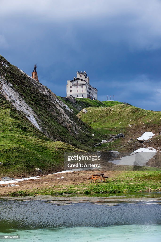 The Petit-Saint-Bernard hospice and statue of Saint Bernard de Menthon at the Little St Bernard Pass in the French Italian Alps
