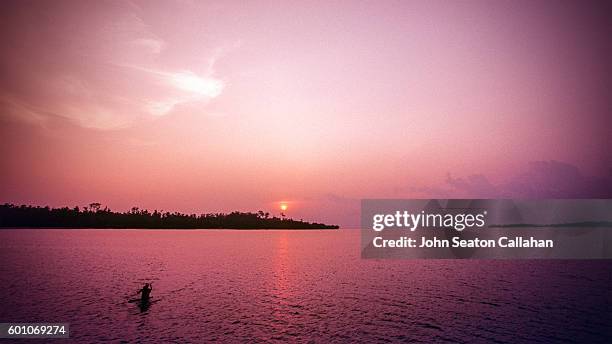 tropical sunset in the mentawai islands - indonesia mentawai canoe stock pictures, royalty-free photos & images