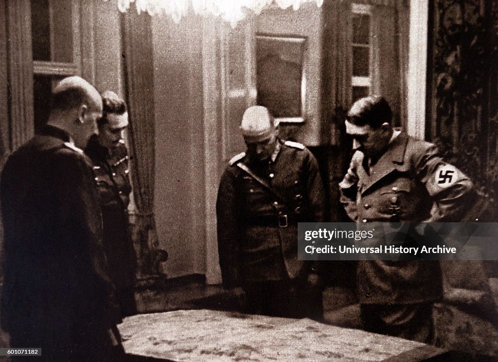 Adolf Hitler, and his generals, looking at a map of former Czechoslovakia.