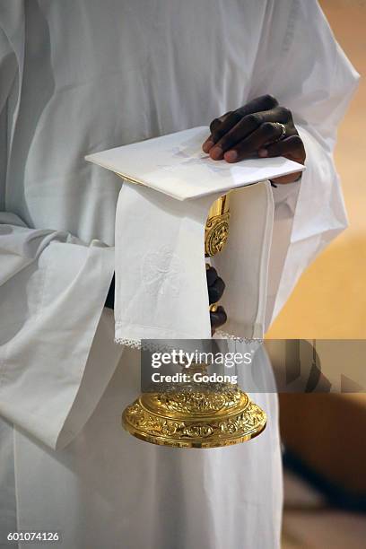 Ars-sur-Fromans. Sanctuary-Shrine of Jean-Marie Vianney . Altar server with a chalice. France.