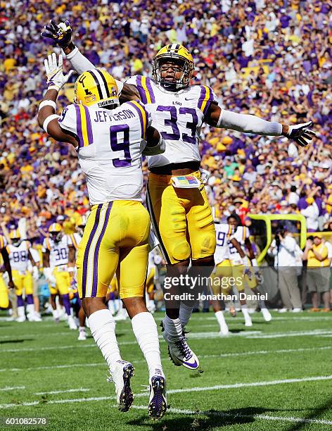 Rickey Jefferson and Jamal Adams of the LSU Tigers celebrate an interception by Jefferson against the Wisconsin Badgers at Lambeau Field on September...