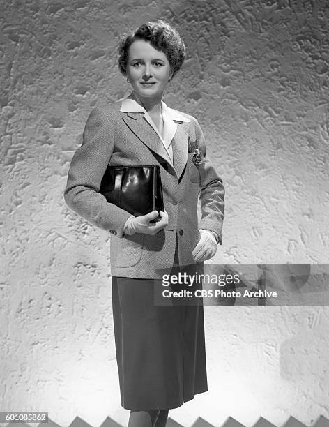 Radio actress Mary Astor models fashions, gowns and suit. Hollywood, CA. Image dated August 3, 1943.