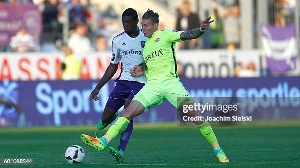 Kwasi Okyere Wriedt of Osnabrueck challenges Manuel Schaeffler of Wiesbaden during the third league match between VfL Osnabrueck and SV Wehen...