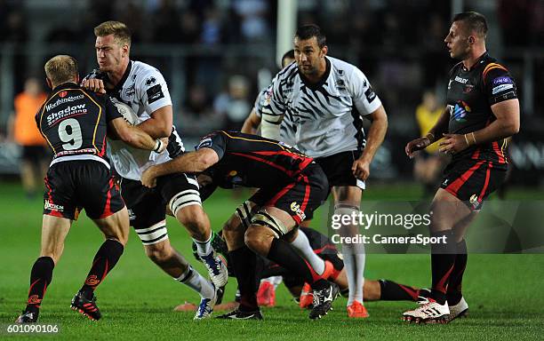 Federico Ruzza of Zebre is tackled by Sarel Pretorius of Dragons during the Guinness PRO12 Round 2 match between Newport Gwent Dragons and Zebre...