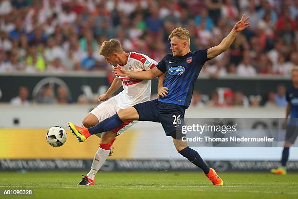 Simon Terodde of Stuttgart fights for the ball with Marcel Titsch-Rivero of Heidenheim during the Second Bundesliga match between VfB Stuttgart and...