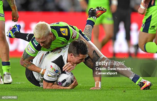 Wigan Warriors' Sam Tomkins tackles Hull FC's Jamie Shaul during the First Utility Super League Super 8s Round 5 match between Hull FC v Wigan...
