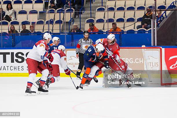Dennis Everberg of Vaxjo Lakers is checked by Sergei Sheleg of Yunost Minsk during the Champions Hockey League match between Vaxjo Lakers and Yunost...