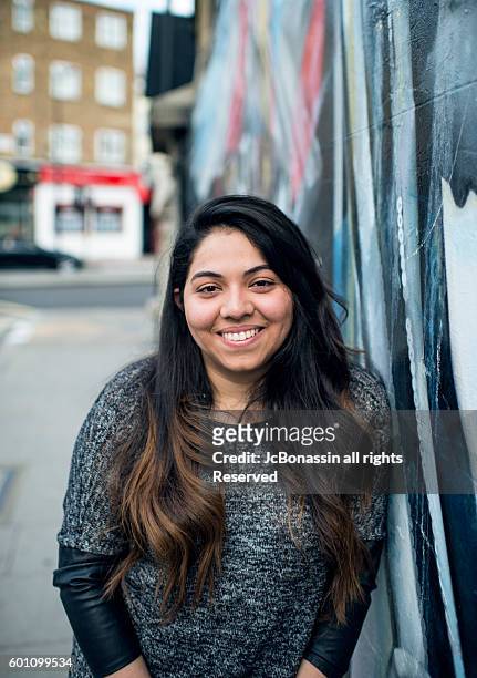 young latin woman smiling - jc bonassin stockfoto's en -beelden