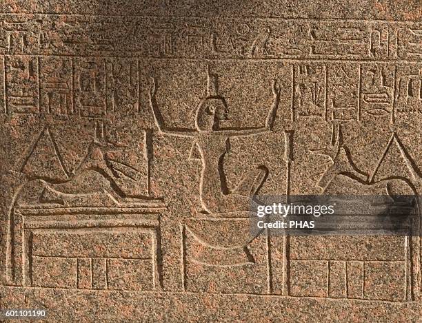 Egyptian Art. Goddess Nephthys, between two figures of god Anubis, wearing a headdress in the shape of a house. Relief. Mit Rahina Open Air Museum,...