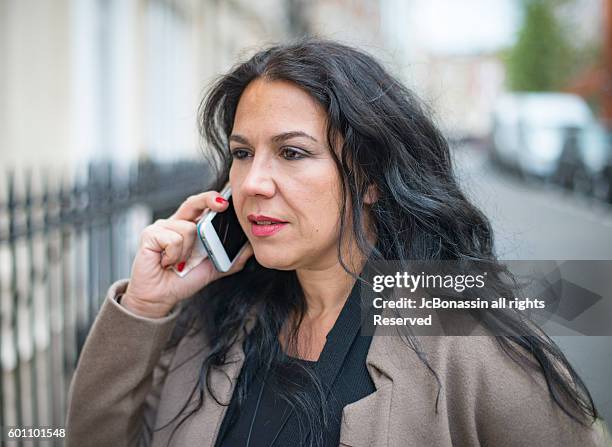 business woman by the phone - jc bonassin ストックフォトと画像