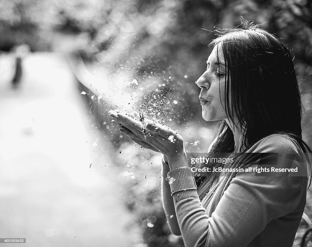 Woman blowing Dust